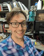 person wearing glasses smiles