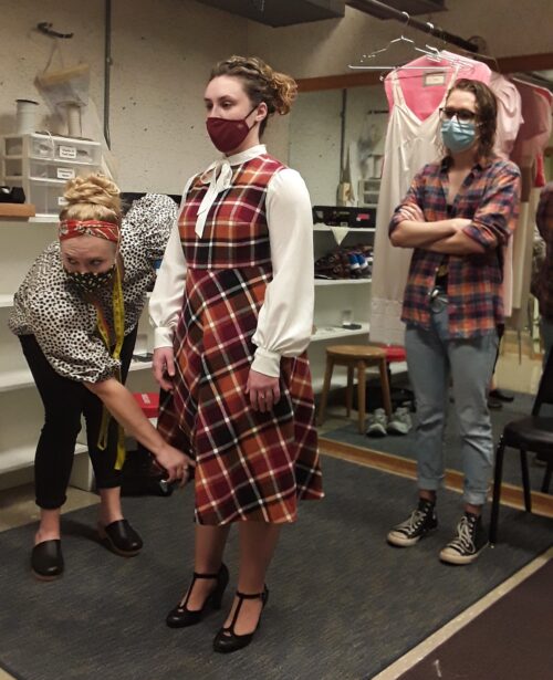 Costume staff conducting a fitting