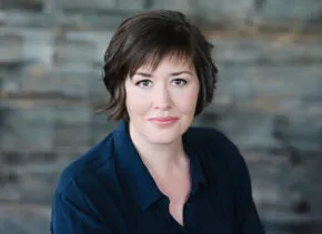 woman with short hair smiles at the camera 