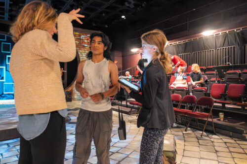 Two actors looking off in the distance during a scene from Tocaya