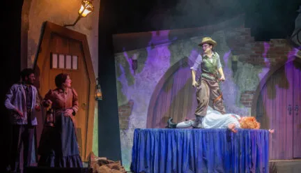 people on stage, one stands on a table