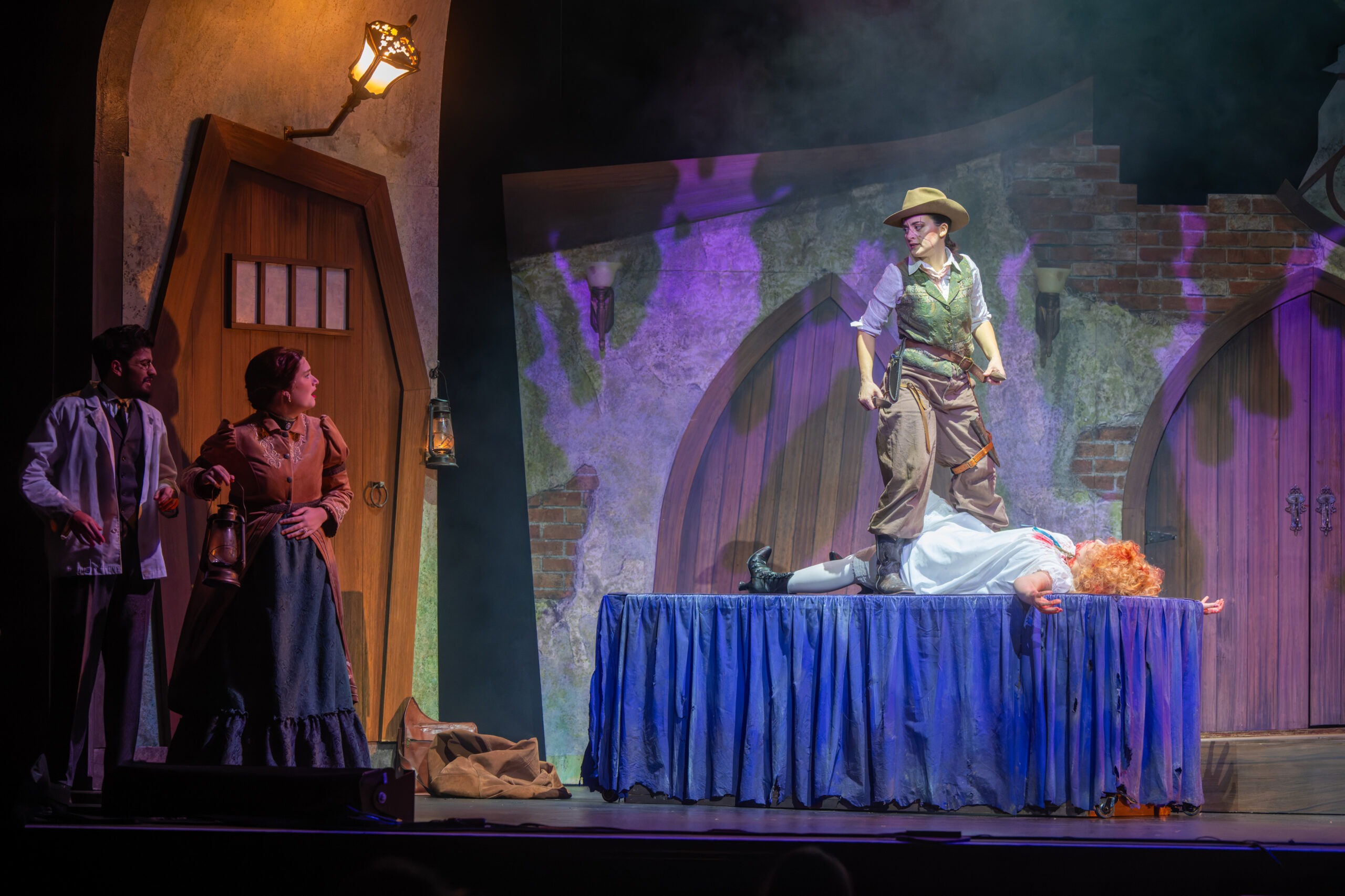 people on stage, one stands on a table