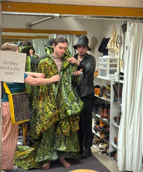 Costume staff conducting a fitting
