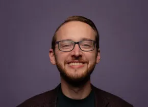 headshot of Matthew smiling and looking at camera