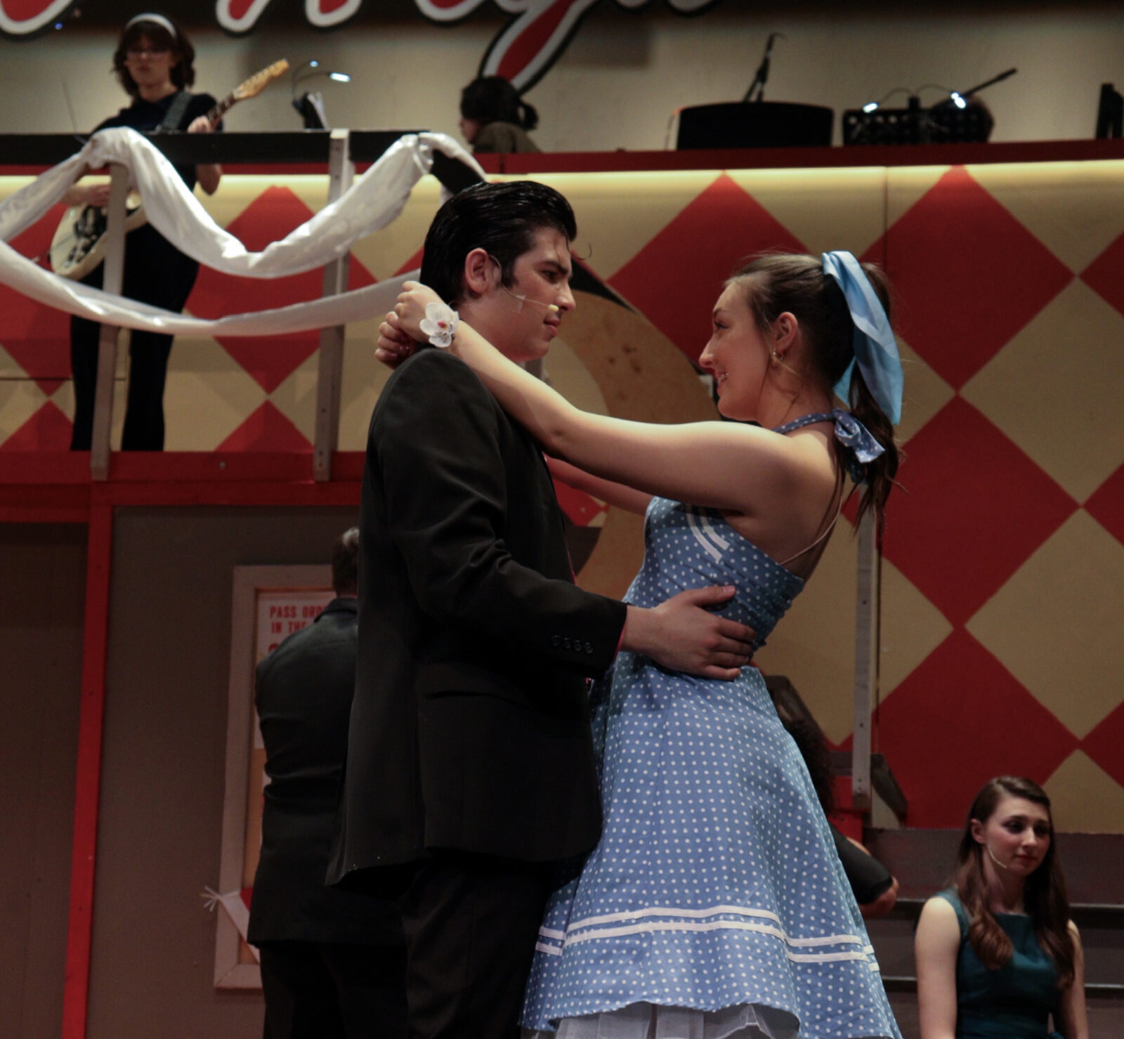 two people hugging onstage