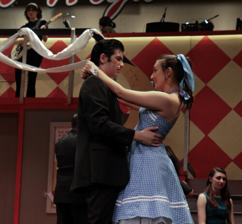 two people hugging onstage