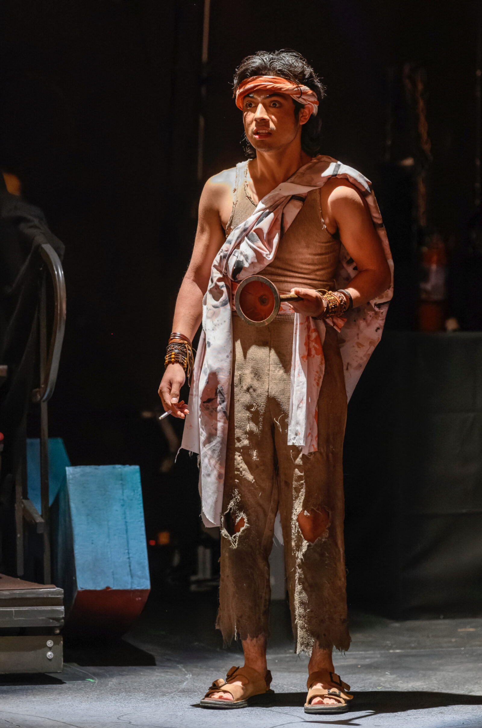 a perosn stands onstage speaking