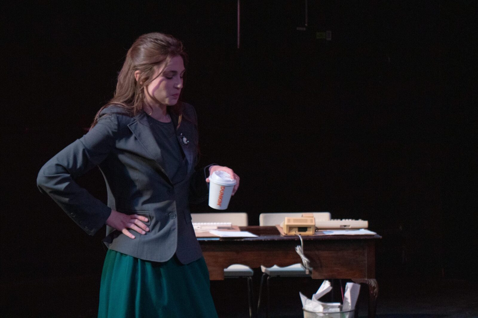 a person onstage with hands on hips