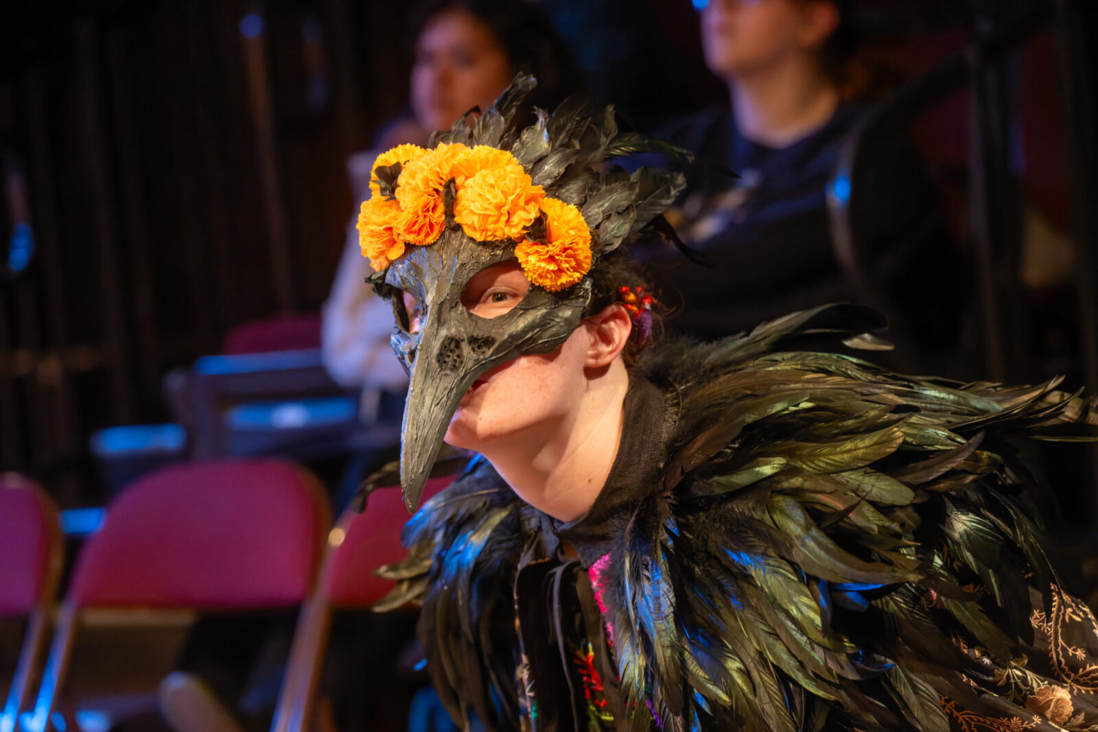 a person onstage dropping lots of pages of script