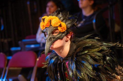 a person onstage dropping lots of pages of script