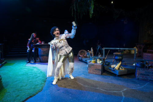 a person onstage holding up a mug