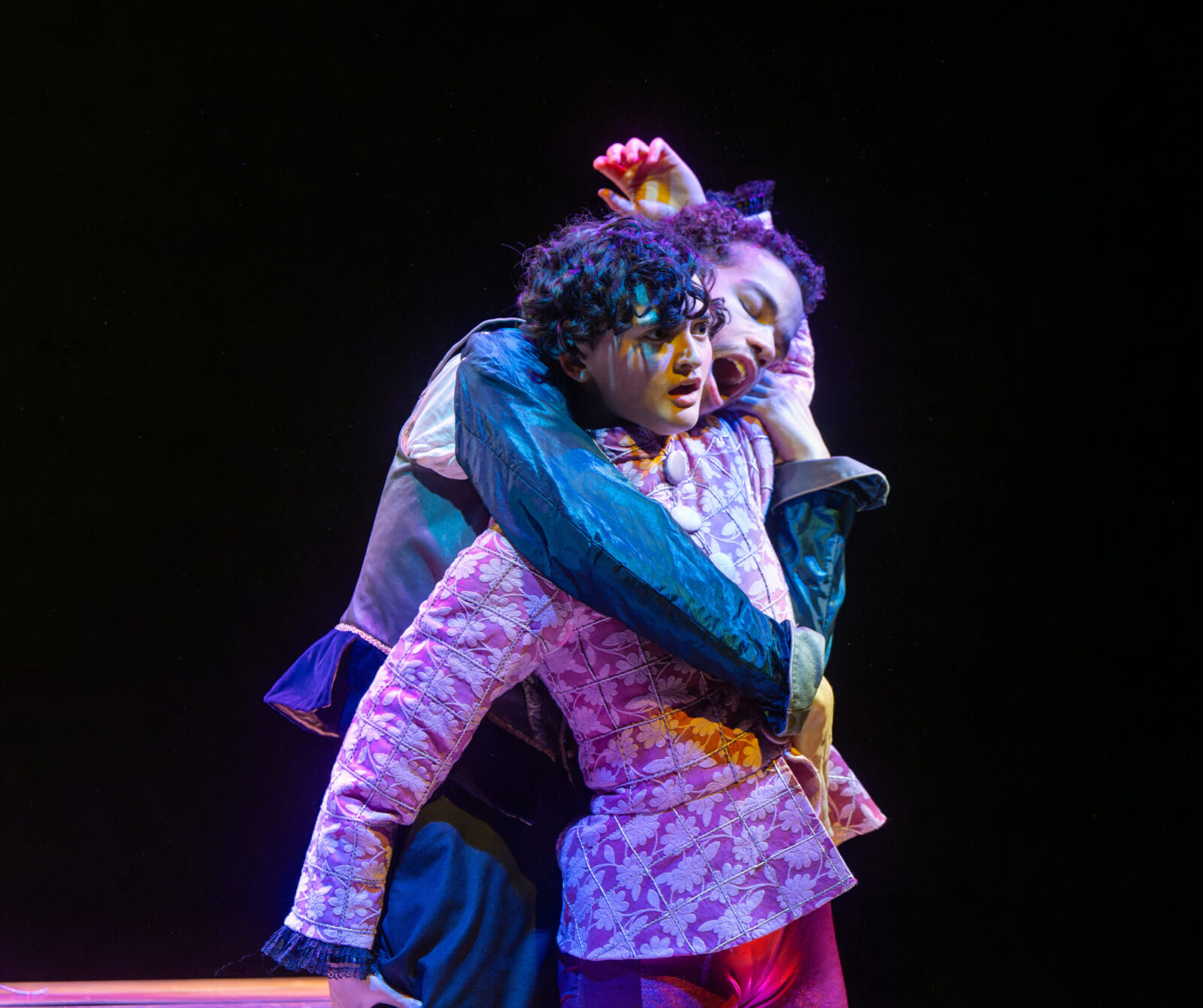 two people onstage holding each other