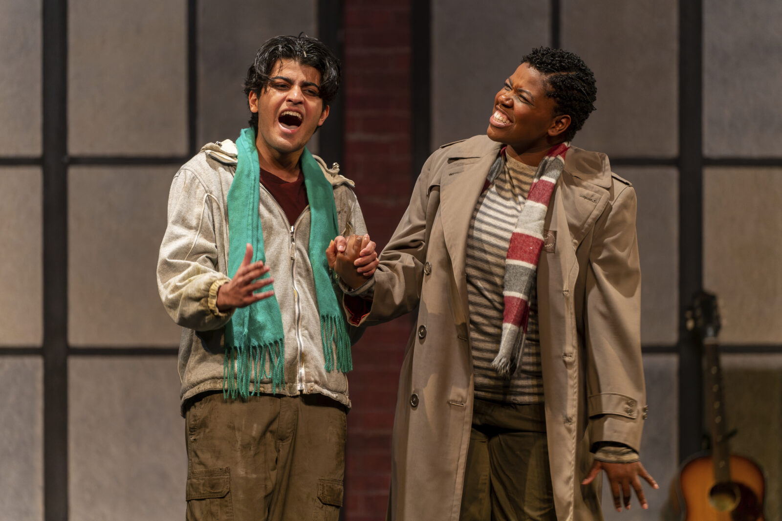 two people onstage in costume singing