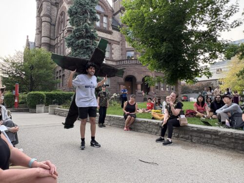 a person carries a cross on their back outdoors