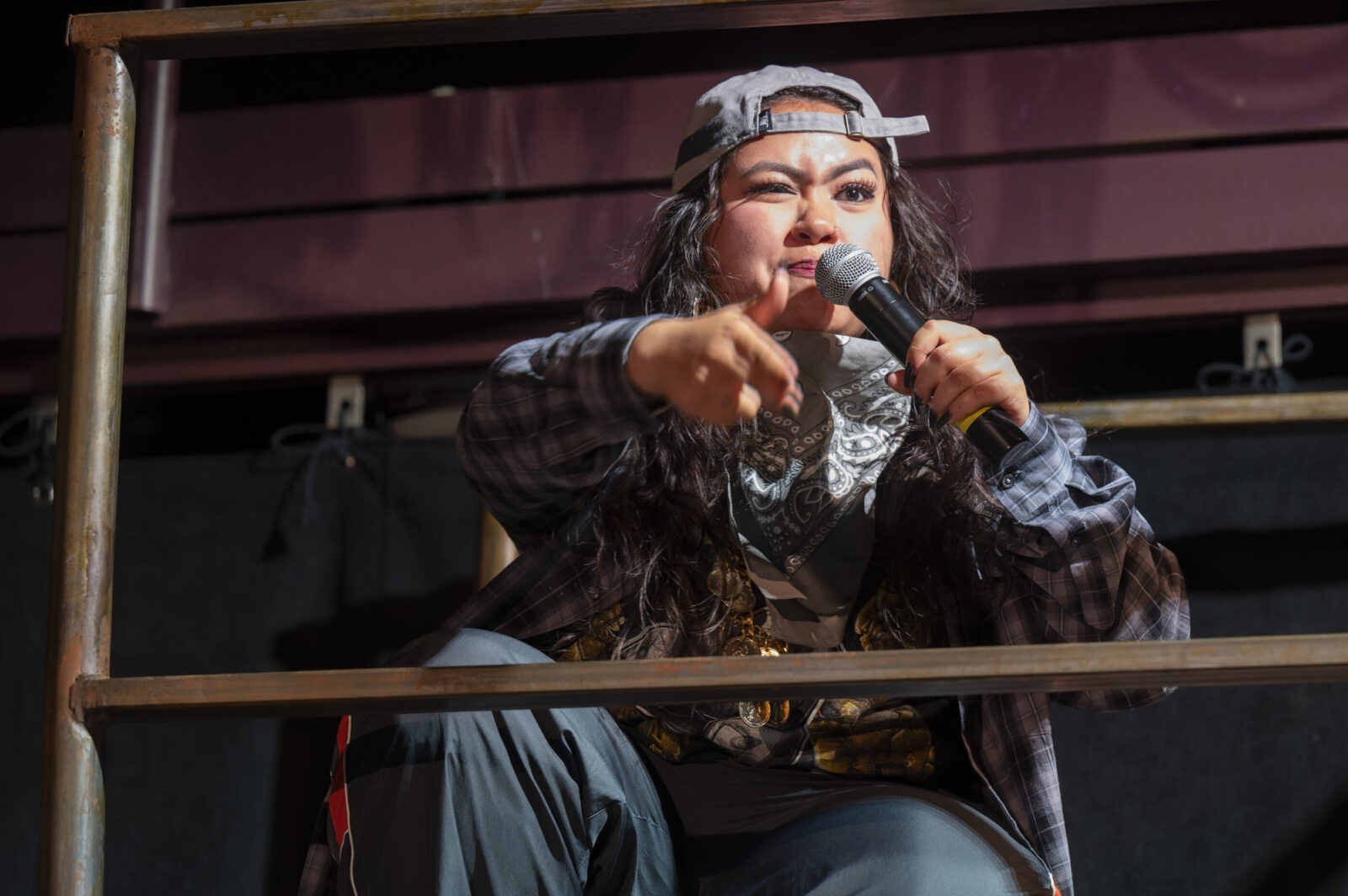 person crouched holding a microphone