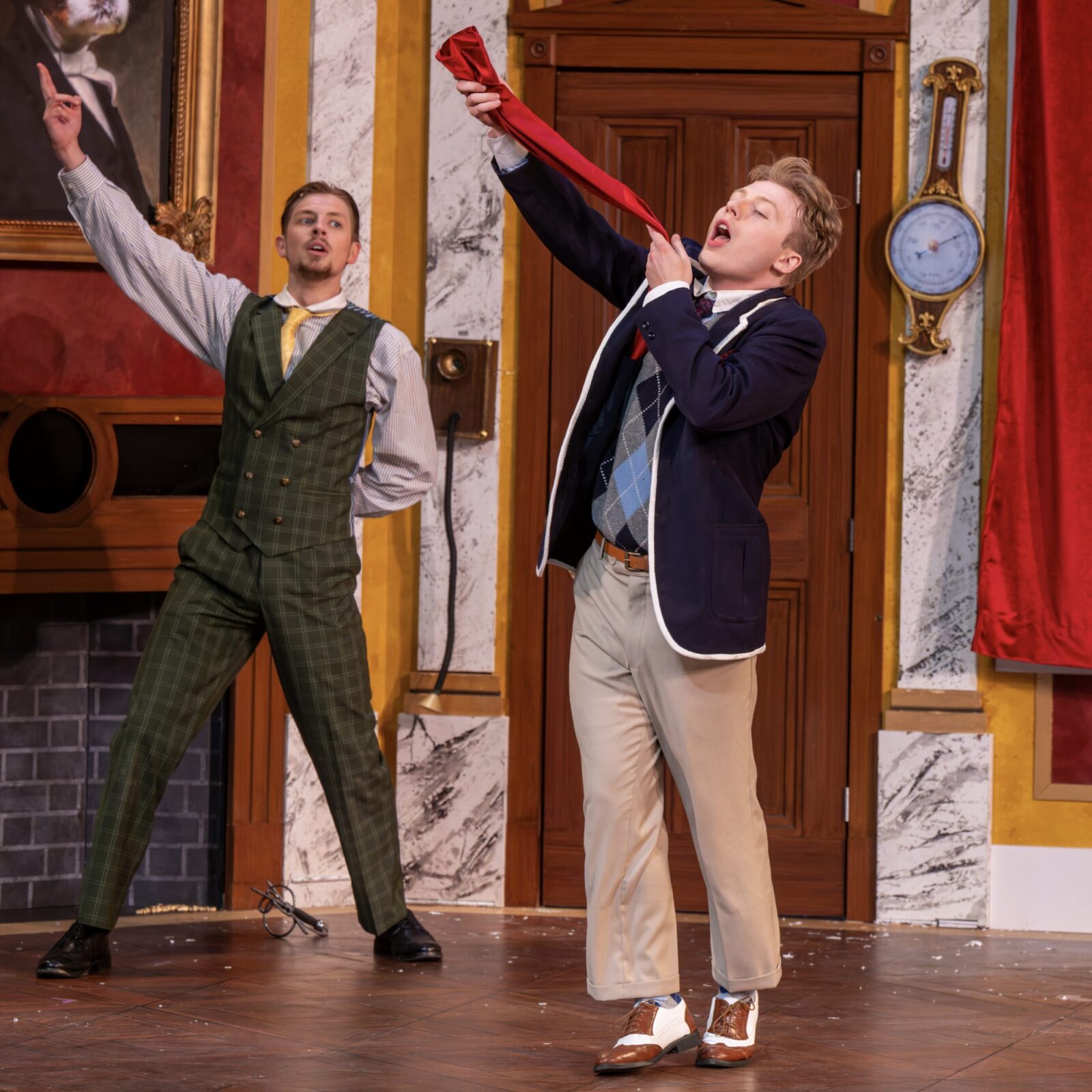 two people onstage with arms raised