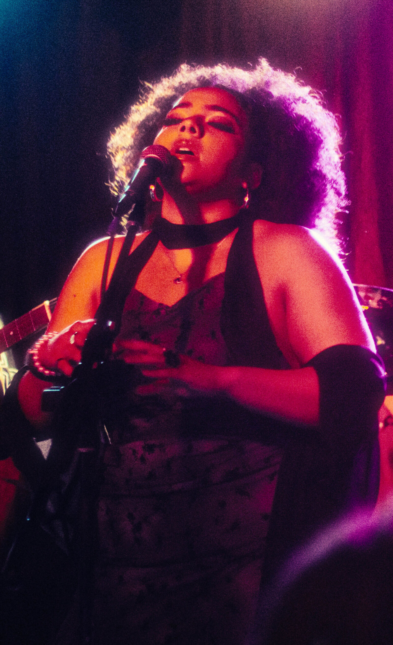 a person onstage singing into a mic