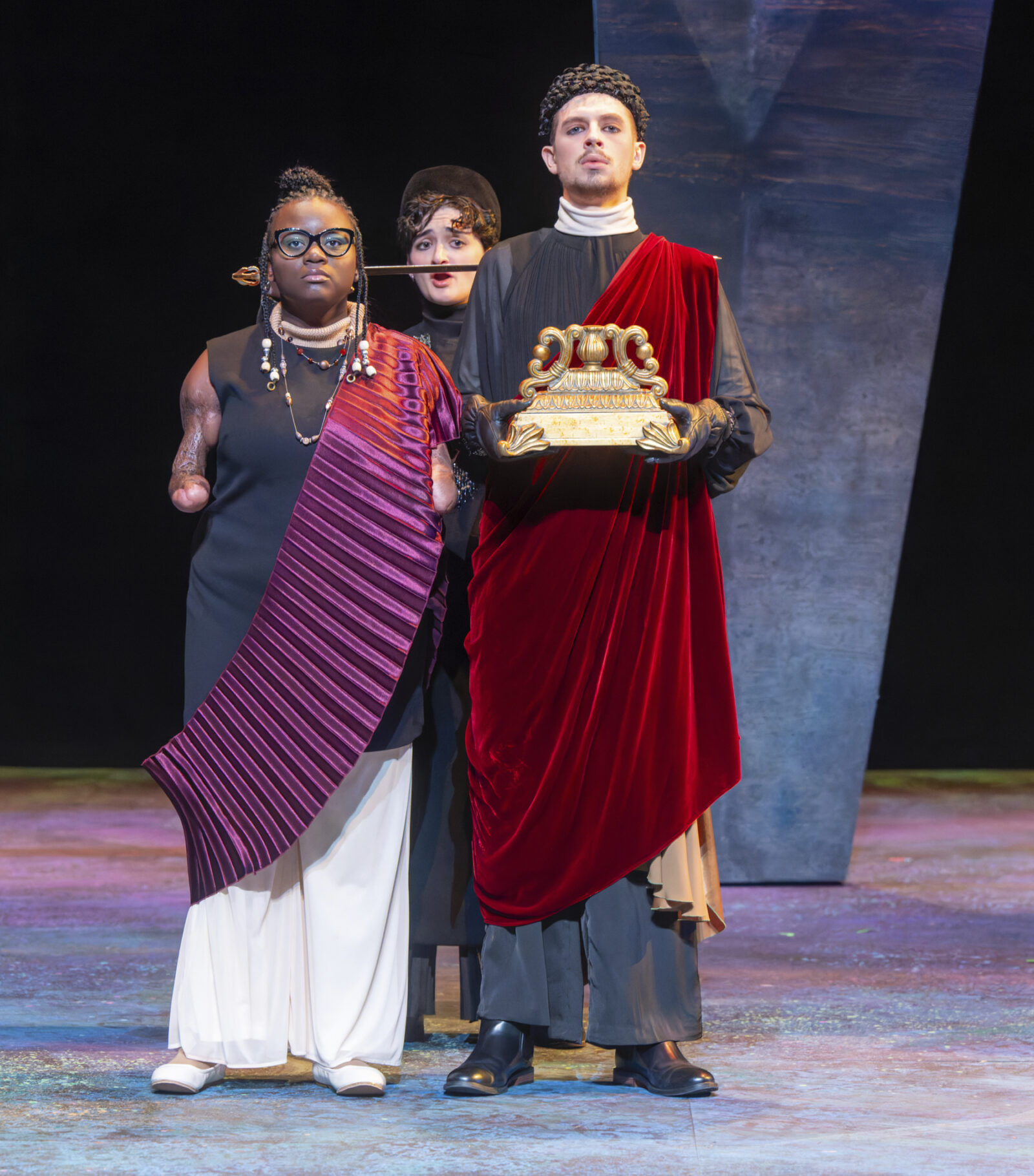 two people onstage standing in a regal manner