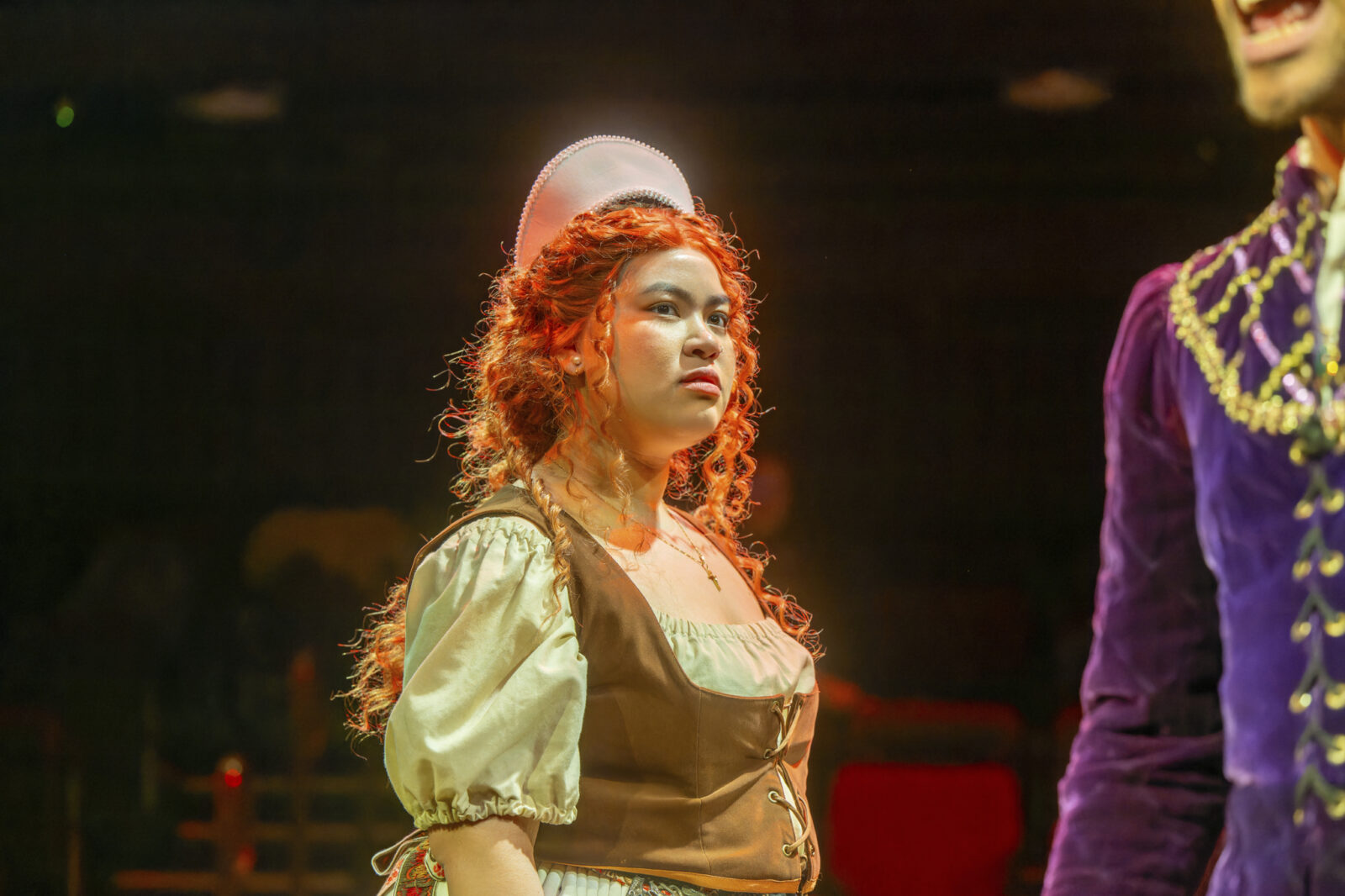 person walks across stage in glowing light