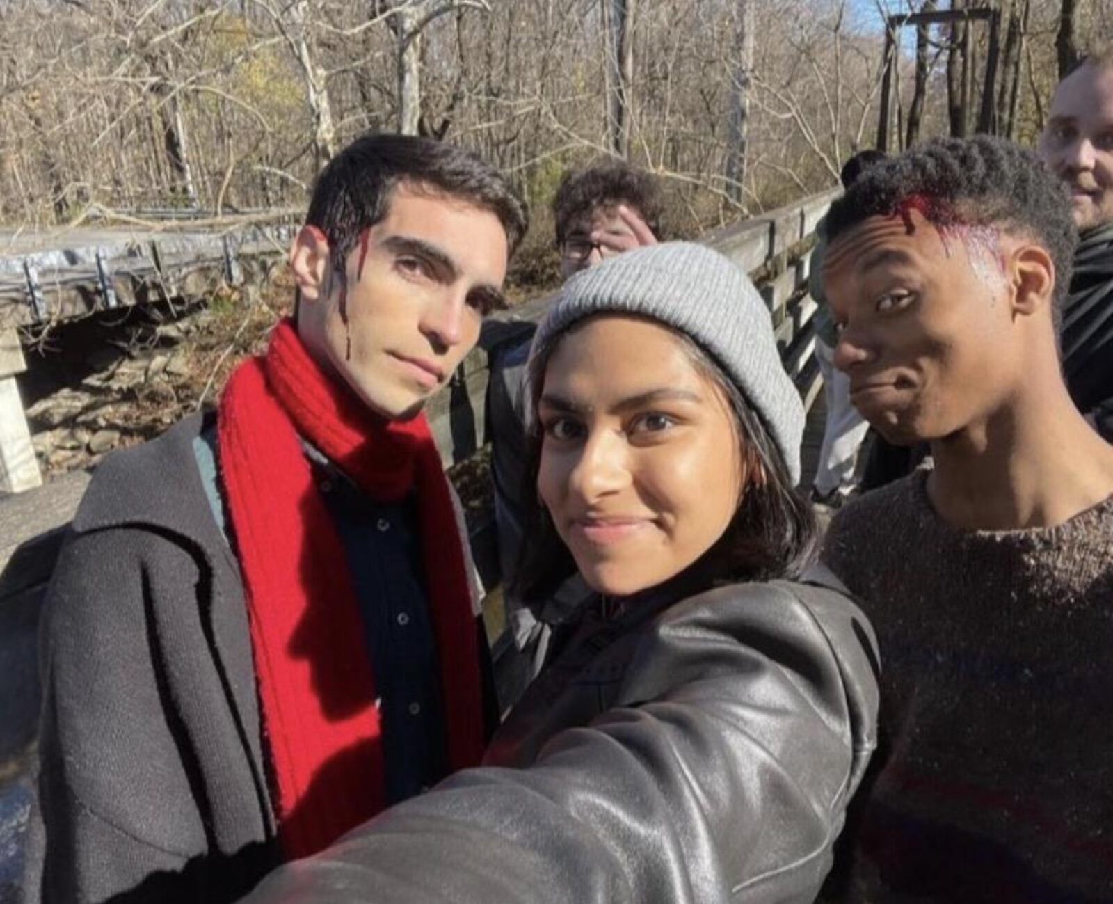 three people with fake blood on them on a film set