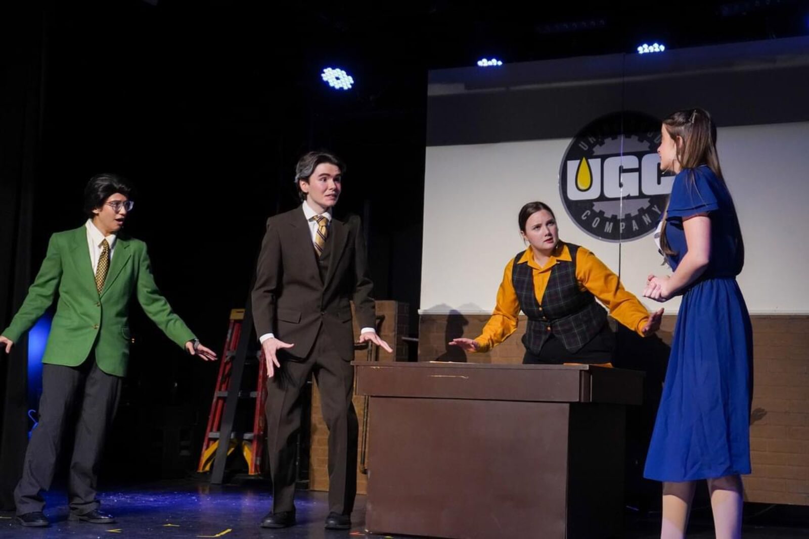 a person onstage holding a crate and picking lettuce