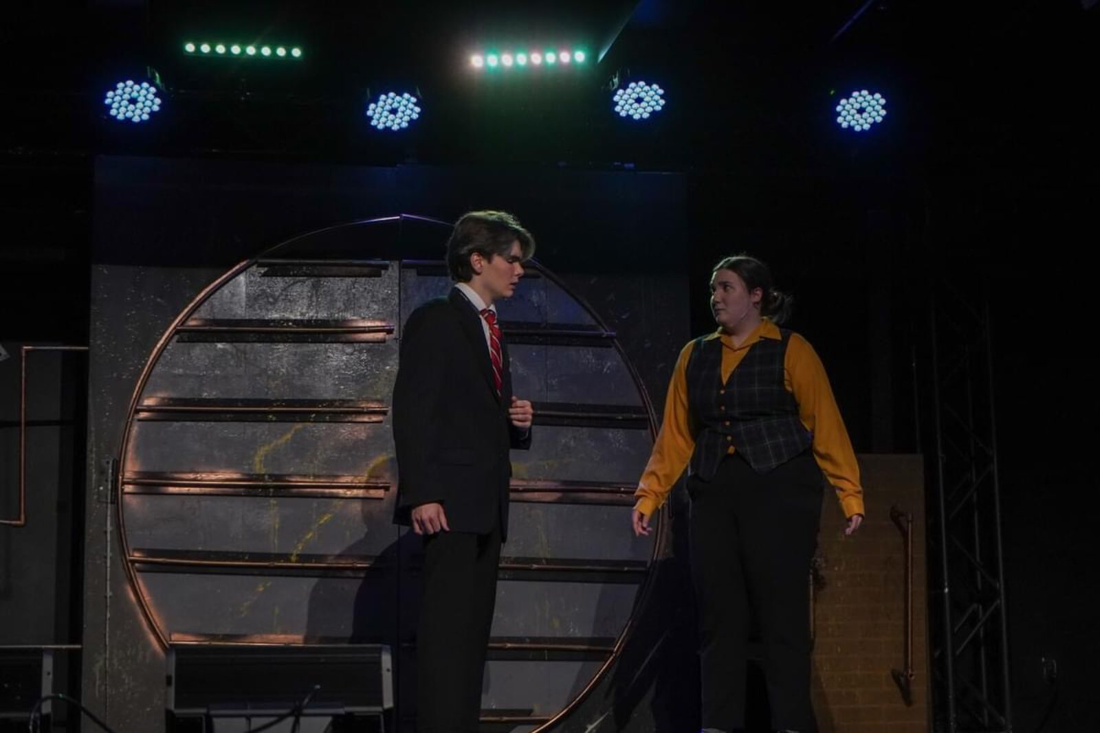 two people standing onstage