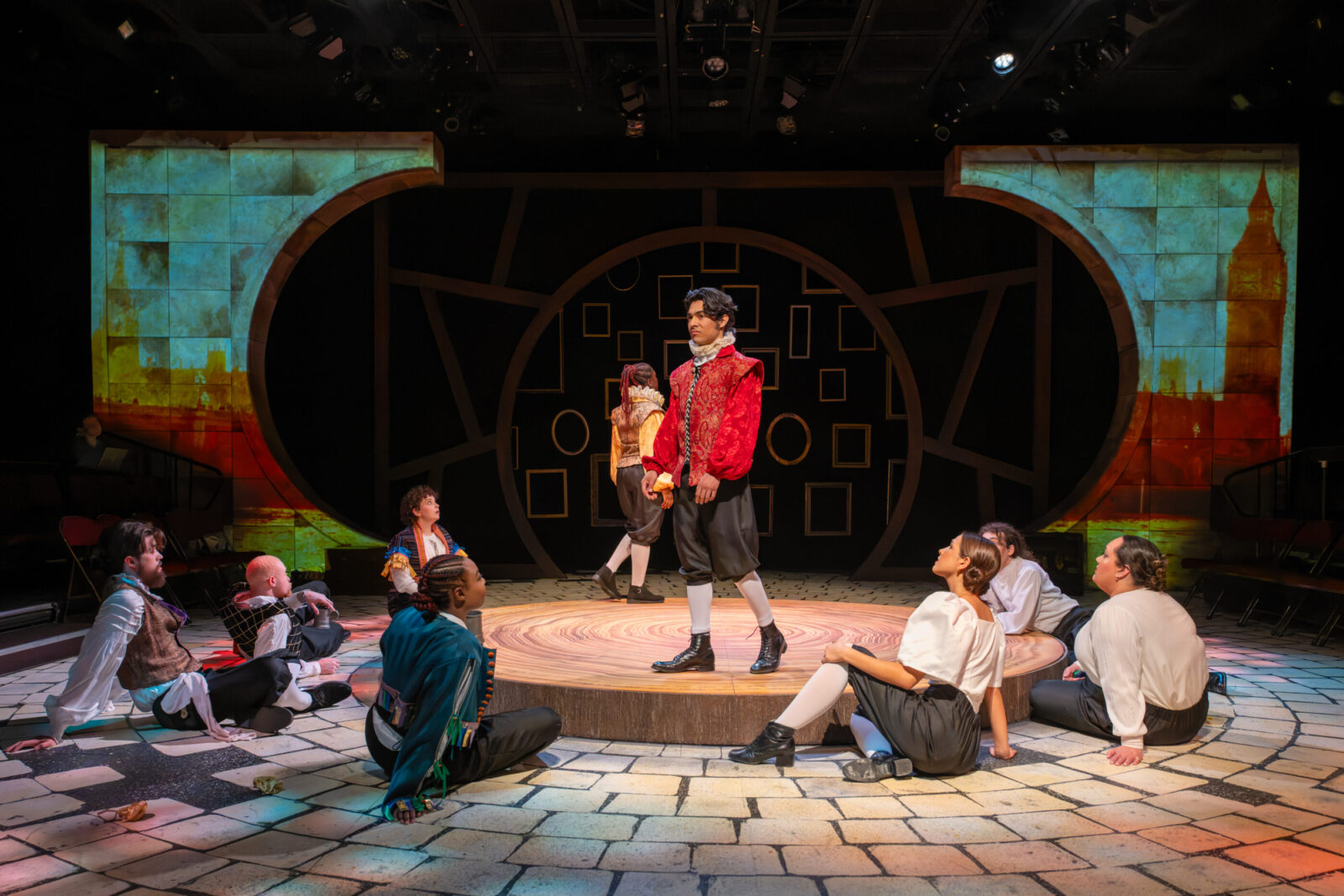 several people onstage, one person holds another person's arm up