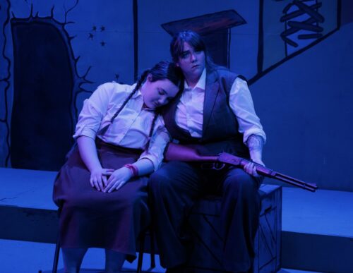 two people standing onstage