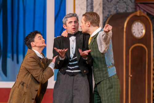 three people chatting onstage