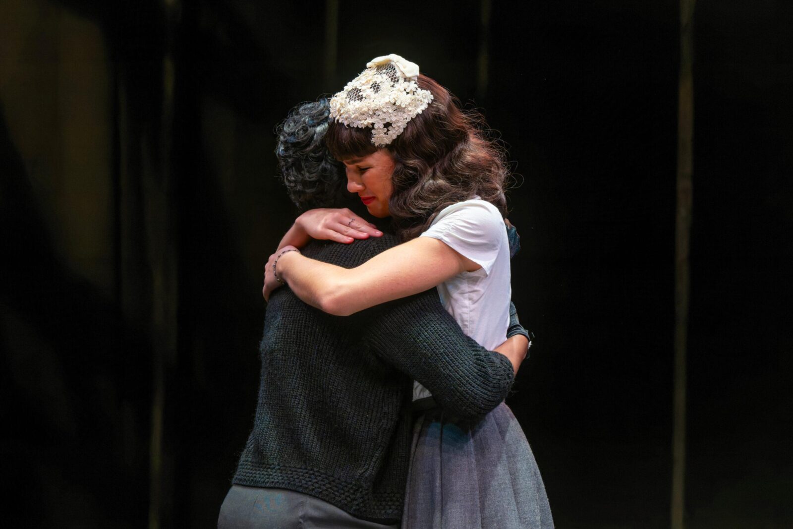 two people onstage hugging