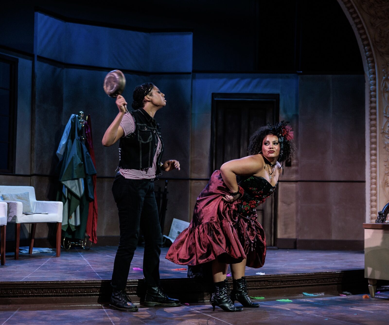 two people onstage, one is about to whack the other one with a pan