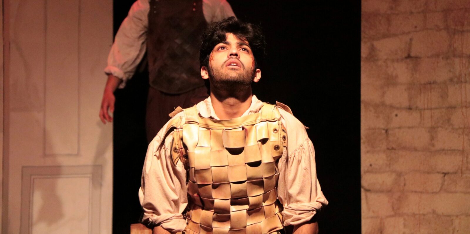 person kneeling looking up in despair