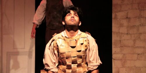 person kneeling looking up in despair