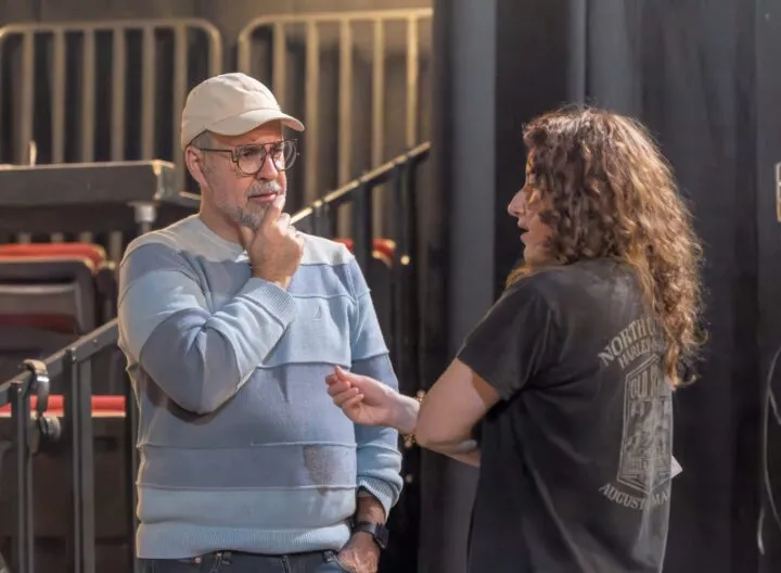 Director consults a designer during a production rehearsal