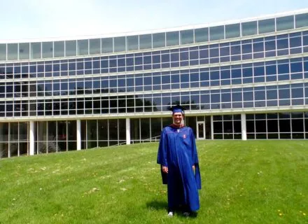 Drew Awsumb (MUP '14) in front of TBH on graduation day.
