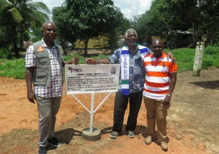 Left: Sam Smith (center), along with Sierra Leone YMCA CEO and Freetown Rotarian Christian Kamara (left) and YMCA Eastern Area Director Frances Amadu (right), commemorate the establishment of a hand pump water well in the Koyagwema Community