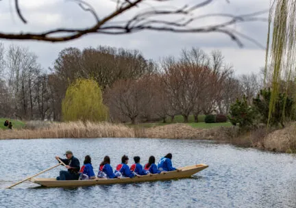 Students and Douglas Brooks testing out the boat they built