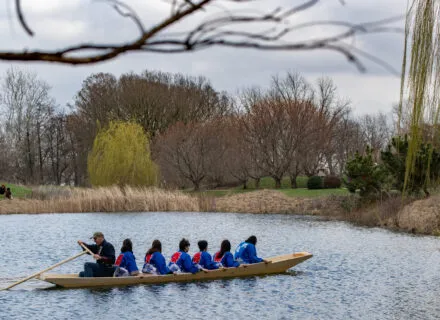 Students and Douglas Brooks testing out the boat they built