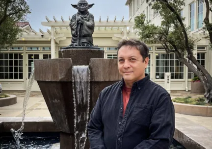 Paul Zinnes in front of Yoda statue