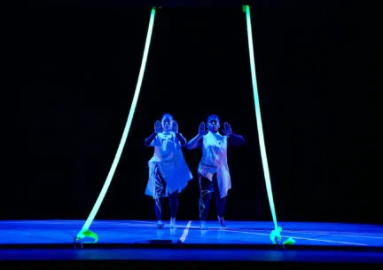 2 dancers perform onstage