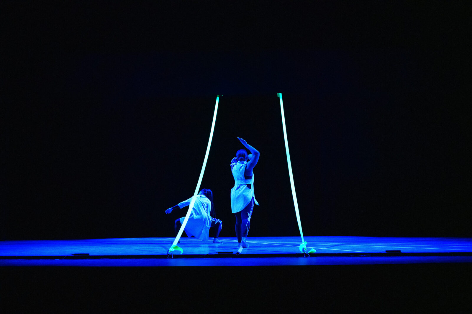 dancers onstage in blue lighting