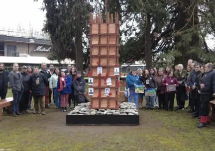 People standing around a memorial outside