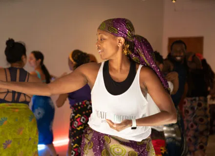 person dances with arms stretched out