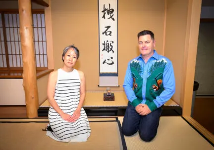 Nick offerman kneels with jennifer gunji at japan house