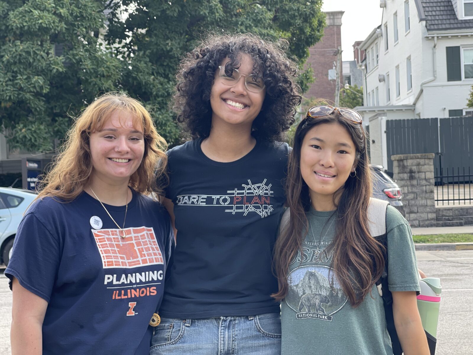 three people hugging and smiling