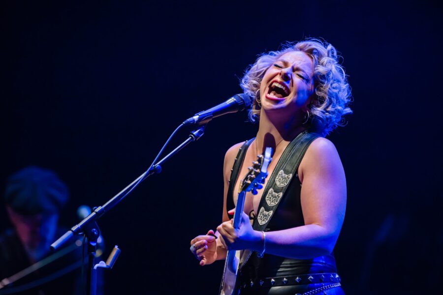 Woman singing and playing guitar