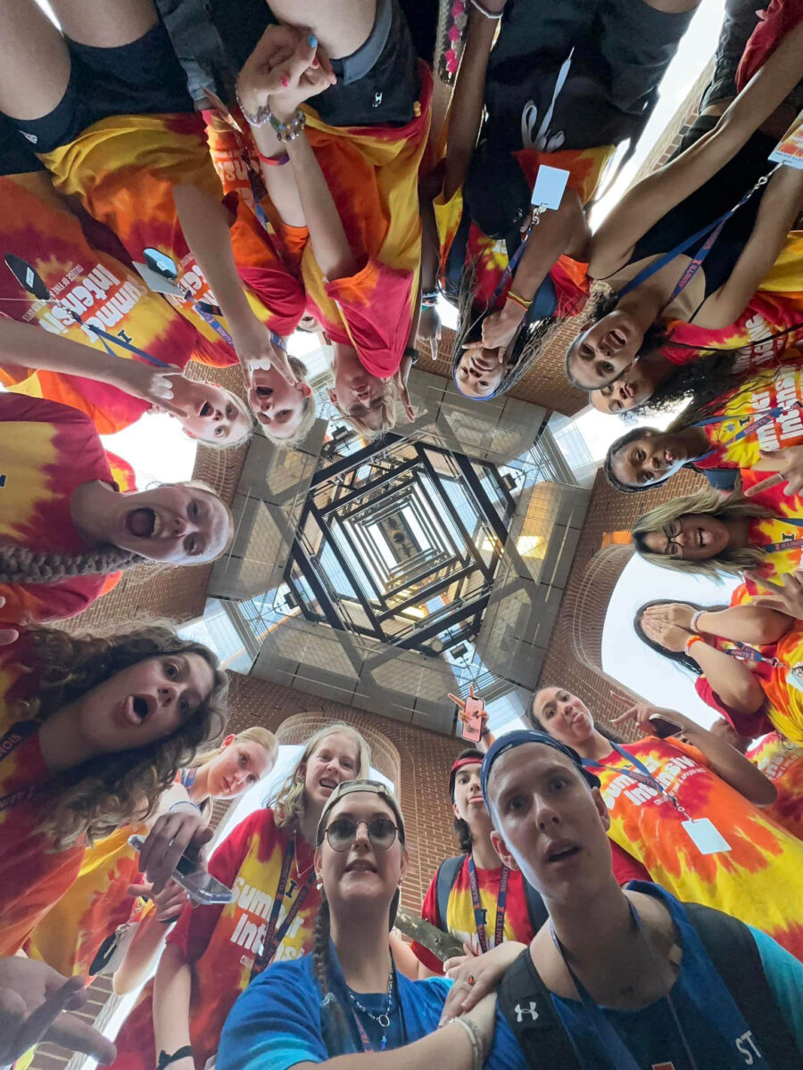 people gathered in a circle looking down