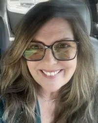 woman smiling in sunglasses