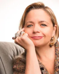 woman resting head on hand with many rings